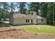 Ranch style home with white siding, green door, brick chimney and mature trees at 3916 W Allen, Raleigh, NC 27603