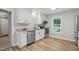 Updated kitchen featuring granite countertops, stainless steel appliances, and modern white cabinetry at 3916 W Allen, Raleigh, NC 27603