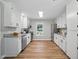Bright kitchen featuring stainless appliances, white cabinets, granite countertops and hardwood flooring at 3916 W Allen, Raleigh, NC 27603