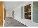 View of the covered porch, showcasing its design with natural wood supports and stylish accent lighting at 3916 W Allen, Raleigh, NC 27603