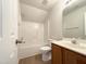 Well-lit bathroom with a vanity, toilet, and shower/tub combination at 4025 Scofield Dr, Raleigh, NC 27610