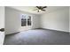 Bedroom with large window and neutral-toned carpet at 4025 Scofield Dr, Raleigh, NC 27610
