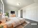 Bright bedroom with a large window, dresser and closet, and warm decor at 4025 Scofield Dr, Raleigh, NC 27610