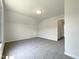 Well-lit bedroom with neutral walls, gray carpeting, and a useful storage area at 4025 Scofield Dr, Raleigh, NC 27610