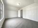 Bedroom featuring neutral carpet, built-in closet, and light interior at 4025 Scofield Dr, Raleigh, NC 27610