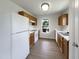 Efficient kitchen with white appliances, wood cabinets, and window at 4025 Scofield Dr, Raleigh, NC 27610