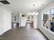 Open floor plan with dining area featuring a modern chandelier and updated flooring at 4025 Scofield Dr, Raleigh, NC 27610