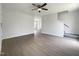 Spacious living room featuring hardwood flooring, a ceiling fan, and a staircase at 4025 Scofield Dr, Raleigh, NC 27610