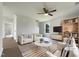 Bright living room with modern furniture, ceiling fan, and large windows offering natural light at 4025 Scofield Dr, Raleigh, NC 27610
