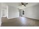 Spacious living room featuring hardwood floors, neutral paint, ceiling fan, and ample natural light at 4025 Scofield Dr, Raleigh, NC 27610