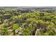 An aerial view shows the houses and lawns in a wooded neighborhood at 4036 Mackenzie Dr, Haw River, NC 27258