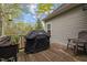 Outdoor deck with grill, wood flooring and seating area for outdoor dining at 4036 Mackenzie Dr, Haw River, NC 27258