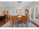 Elegant dining room with modern lighting, a wooden table with seating for six, and large windows at 4036 Mackenzie Dr, Haw River, NC 27258
