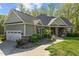 Beautiful home featuring stone accents, a well-manicured lawn, and an attached two-car garage at 4036 Mackenzie Dr, Haw River, NC 27258