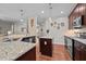 Well-appointed kitchen with granite countertops, wood cabinets, and modern appliances at 4036 Mackenzie Dr, Haw River, NC 27258
