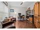 Inviting home office with hardwood floors, comfortable seating, and ample natural light at 4036 Mackenzie Dr, Haw River, NC 27258