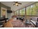 Relaxing screened porch with stylish furniture, ceiling fans, and views of the yard at 4036 Mackenzie Dr, Haw River, NC 27258