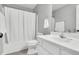 Neutral bathroom with a shower/tub combo, sink with white cabinets, and light gray walls at 404 Southerby Dr, Garner, NC 27529