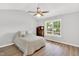 Neutral bedroom is brightly lit with a large window and features wood floors and a ceiling fan at 404 Southerby Dr, Garner, NC 27529