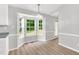 Bright dining area features beautiful bay window with lovely backyard views and updated light fixture at 404 Southerby Dr, Garner, NC 27529