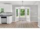 Bright dining area featuring large windows, wood floors, and a modern chandelier at 404 Southerby Dr, Garner, NC 27529