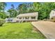 Well-kept single-story home featuring a front porch and a long driveway at 404 Southerby Dr, Garner, NC 27529
