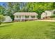 Charming single-story home with a welcoming front porch and lush green lawn at 404 Southerby Dr, Garner, NC 27529