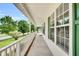 Extended front porch with white railing and green shutters on a charming home at 404 Southerby Dr, Garner, NC 27529