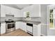 Updated kitchen featuring white cabinets, laminate countertops, and stainless steel appliances at 404 Southerby Dr, Garner, NC 27529