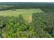 Aerial photo capturing a home situated on a property with lush greenery and a refreshing swimming pool at 406 Johns Woods Rd, Chapel Hill, NC 27516