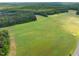 Sprawling aerial view showing off the property's landscape, filled with mature greenery and open land at 406 Johns Woods Rd, Chapel Hill, NC 27516