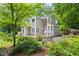 Home featuring a landscaped backyard, complete with mature trees, patio, and outdoor seating area at 406 Johns Woods Rd, Chapel Hill, NC 27516