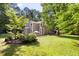 Home featuring a spacious lawn and landscaped yard with a charming outdoor seating area at 406 Johns Woods Rd, Chapel Hill, NC 27516