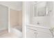 Bright bathroom with a white vanity, tiled shower-tub, and a mirror in a well-lit space at 406 Johns Woods Rd, Chapel Hill, NC 27516