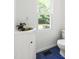 Cozy bathroom featuring blue tile flooring, toilet, and unique sink vanity at 406 Johns Woods Rd, Chapel Hill, NC 27516