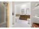 Bathroom featuring a shower, soaking tub, and double sink vanity at 406 Johns Woods Rd, Chapel Hill, NC 27516
