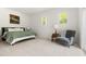Bright bedroom with neutral carpet, sitting chair, and windows with natural light at 406 Johns Woods Rd, Chapel Hill, NC 27516
