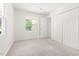 Bright bedroom with natural light, a closet, and a large window showing the outdoors at 406 Johns Woods Rd, Chapel Hill, NC 27516
