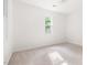 Empty bedroom with two windows and neutral carpet at 406 Johns Woods Rd, Chapel Hill, NC 27516