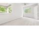 Bright bedroom with large windows and a ceiling fan at 406 Johns Woods Rd, Chapel Hill, NC 27516