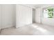 Bright bedroom with white walls, neutral carpet, closet, and a window with natural light at 406 Johns Woods Rd, Chapel Hill, NC 27516