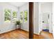 Sun-filled bonus room featuring hardwood floors, wood beams, and lots of windows at 406 Johns Woods Rd, Chapel Hill, NC 27516