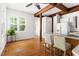 Sun-filled dining area featuring wood beams, hardwood floors, and large windows at 406 Johns Woods Rd, Chapel Hill, NC 27516