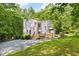 Charming multi-story home featuring a wood-lined exterior, set against a backdrop of lush trees at 406 Johns Woods Rd, Chapel Hill, NC 27516