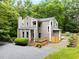 Attractive multi-story home featuring a wood-lined exterior, complemented by lush greenery at 406 Johns Woods Rd, Chapel Hill, NC 27516