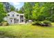 Charming home featuring a well-maintained lawn and landscaped backyard with mature trees at 406 Johns Woods Rd, Chapel Hill, NC 27516