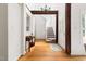 Bright foyer with hardwood floors, complemented by a staircase, wood beams, and natural light at 406 Johns Woods Rd, Chapel Hill, NC 27516