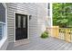 Cozy front porch featuring a decorative glass door, wood railings, and charming landscape at 406 Johns Woods Rd, Chapel Hill, NC 27516