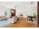 Comfortable living room with a stone fireplace, hardwood floors, and natural light at 406 Johns Woods Rd, Chapel Hill, NC 27516