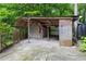 Open-air outbuilding with concrete flooring, storage, and access to the backyard at 406 Johns Woods Rd, Chapel Hill, NC 27516